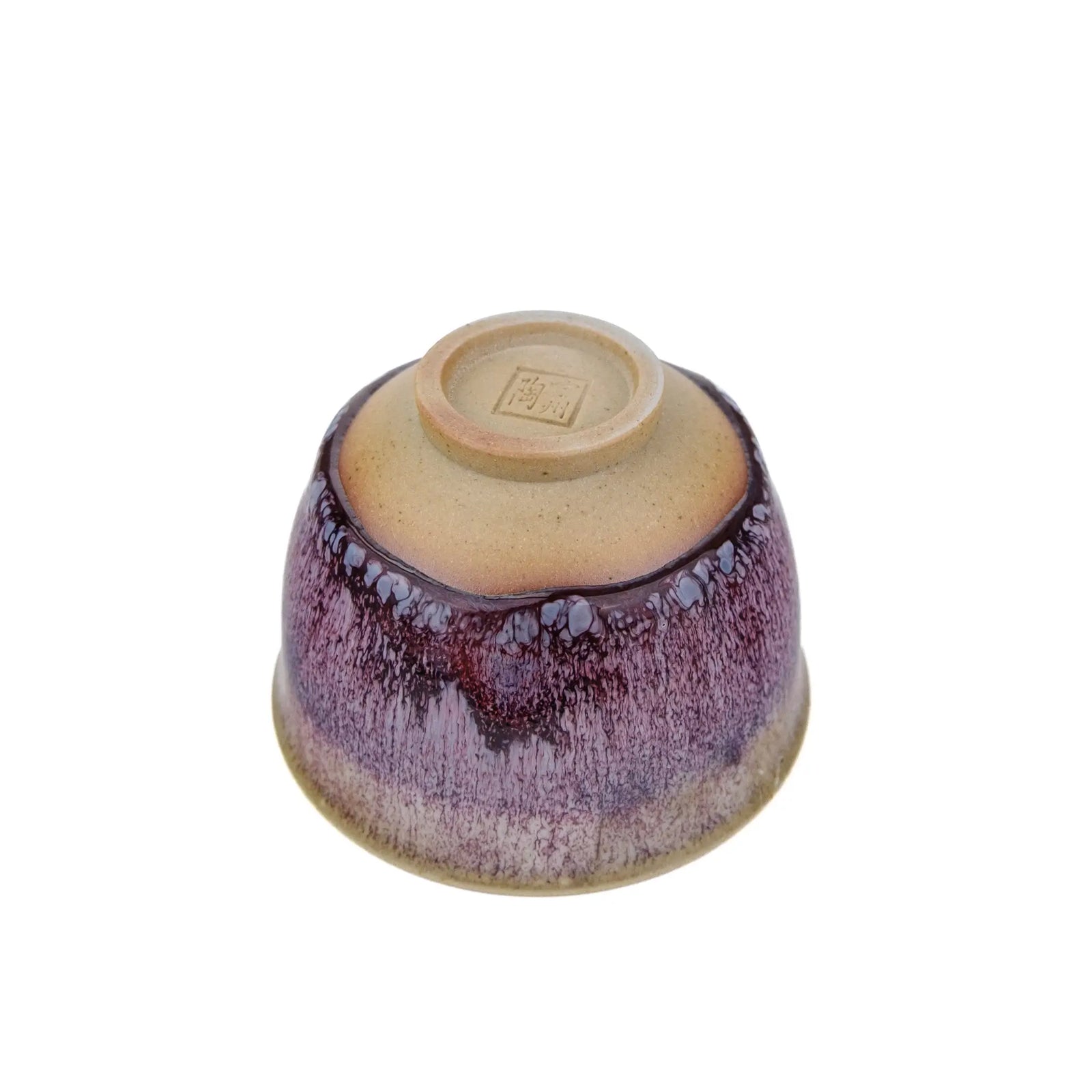 Underside view of Handmade Huaning Pottery Tea Cup for Gong Fu Tea - Variable Purple Glaze with an unglazed cup foot. The artist's stamp is on the bottom exterior of the cup.
