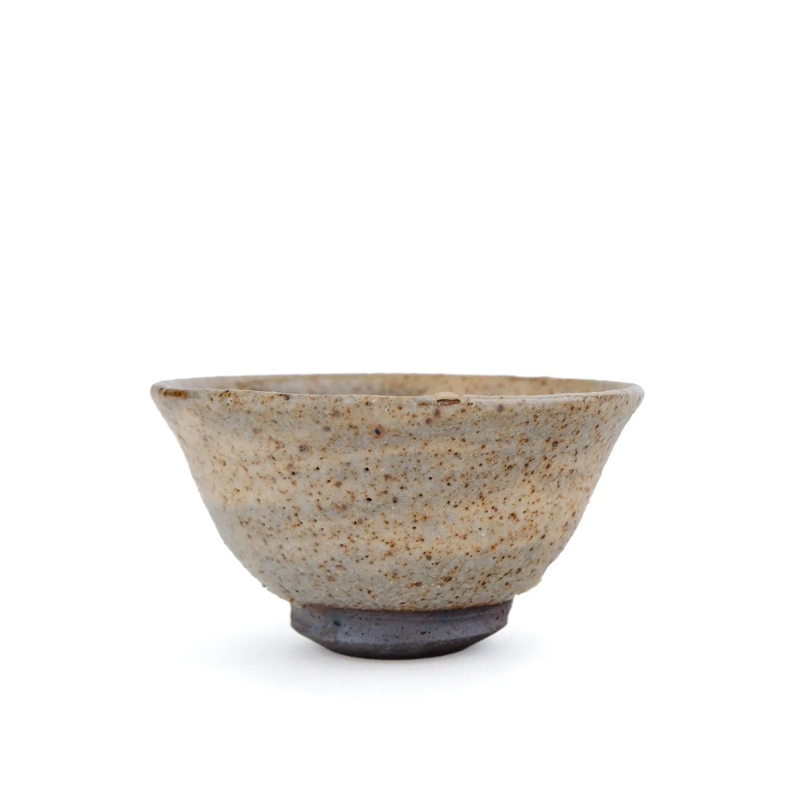 A handmade ceramic gong fu teacup with a textured, speckled glaze in earthy beige and brown tones, set against a plain white background - another view