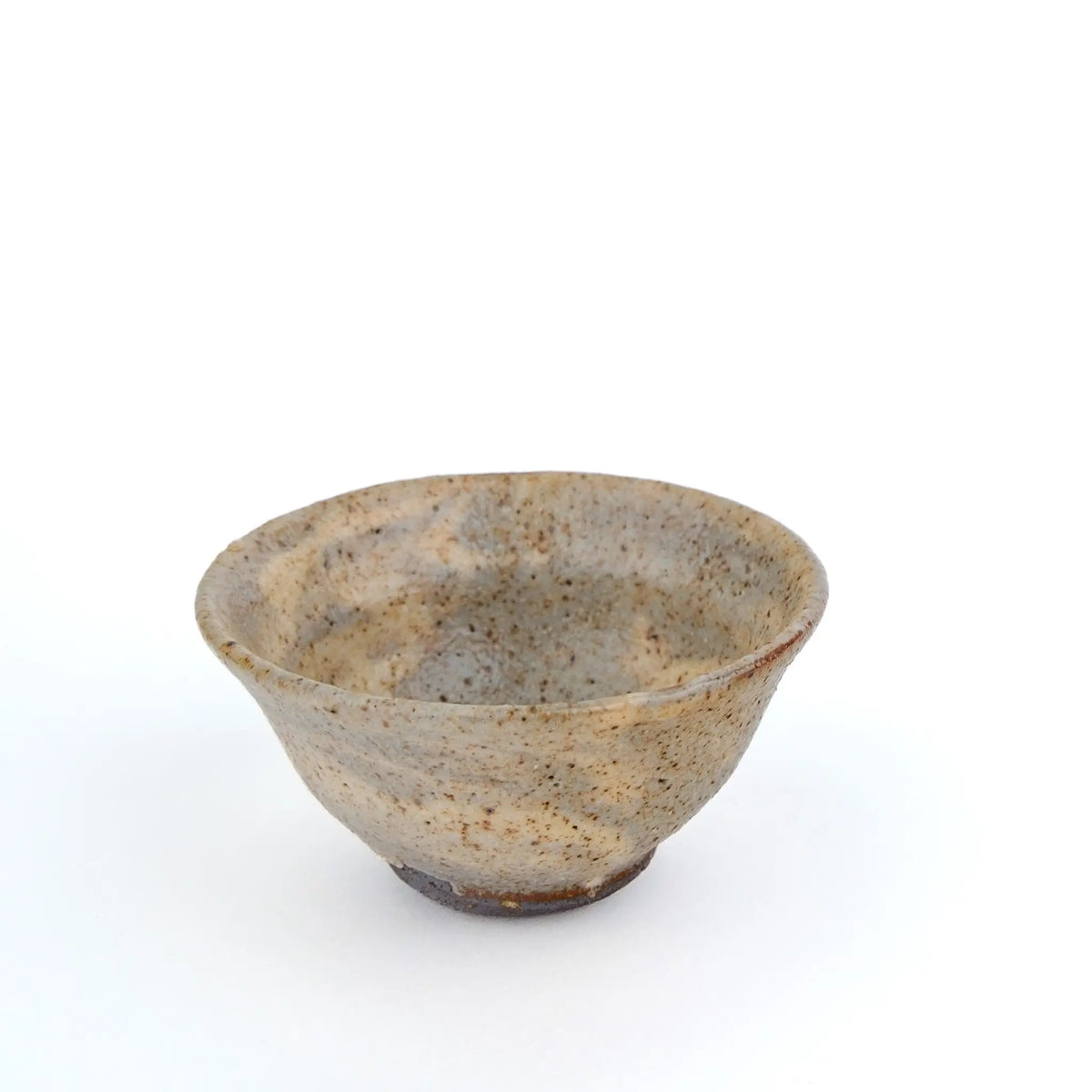 A handmade ceramic gong fu teacup with a textured, speckled glaze in earthy beige and brown tones, set against a plain white background - another side view