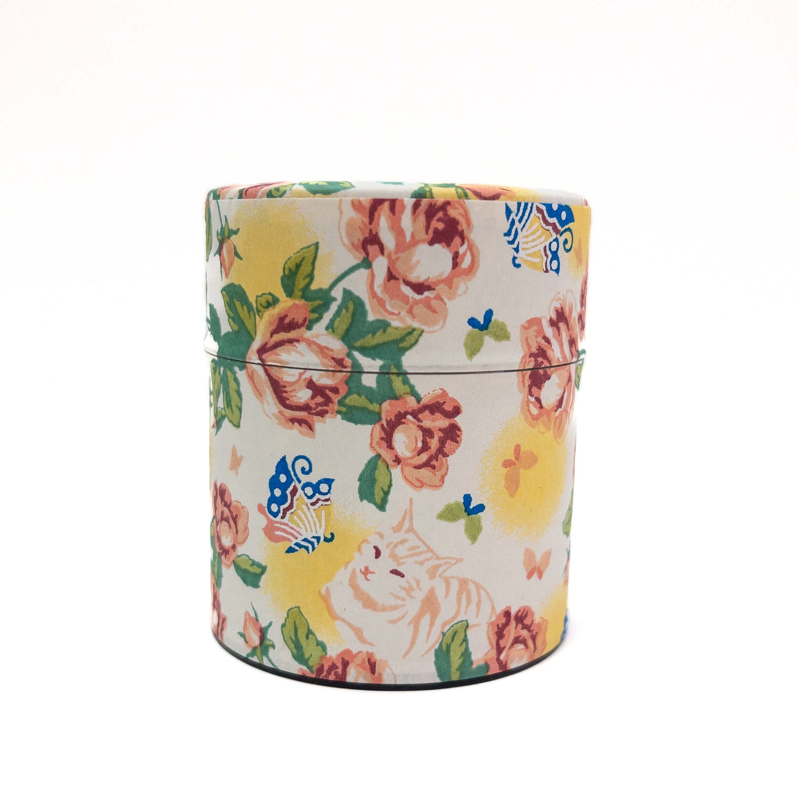 Cylindrical tea container with floral and cat design on a white background