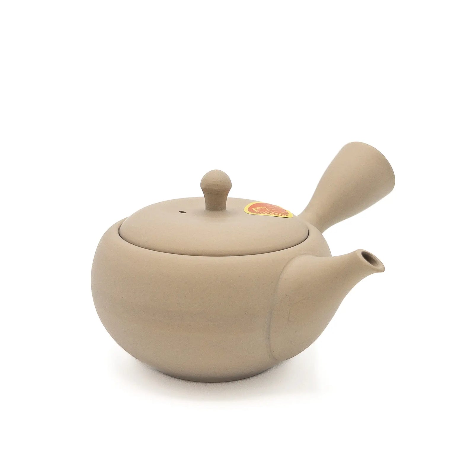 Beige Japanese teapot on a white background